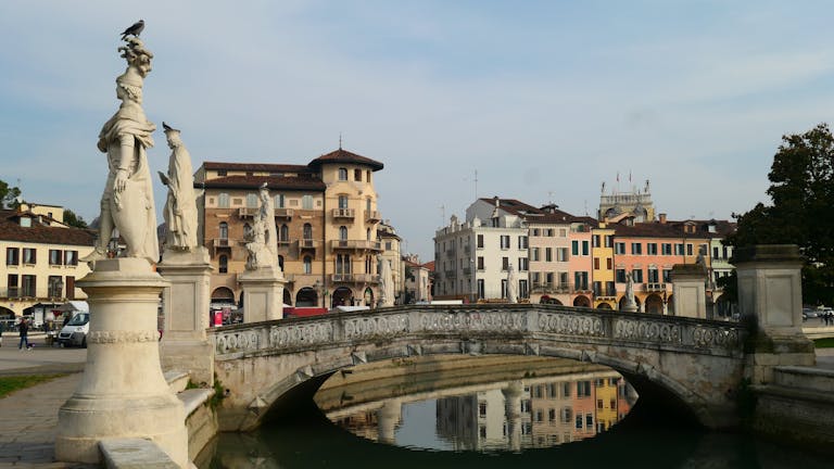 Beautiful view of Prato della Valle with Venetian architecture and statues in Padova, Italy.